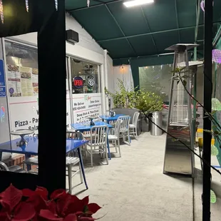 a patio with tables and chairs