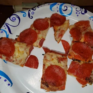 slices of pepperoni pizza on a paper plate