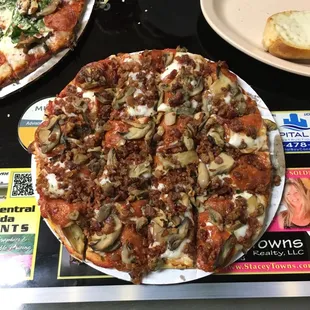 Pepperoni, bacon and mushroom pizza