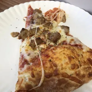 a slice of pizza on a paper plate