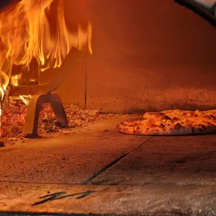 a fire coming out of a brick oven