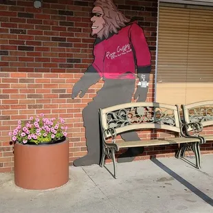 a woman on a bench in front of a restaurant