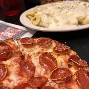 Small pepperoni pizza and cheese tortellini with Alfredo sauce.