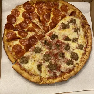 a pepperoni and sausage pizza in a box