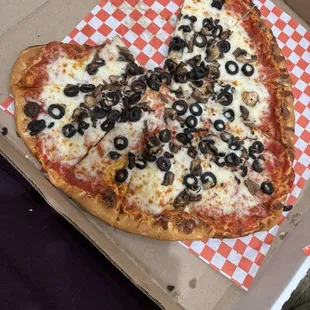 Heart shaped medium thin crust pizza with olives and mushrooms.