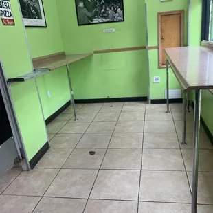 a kitchen with green walls and tile flooring