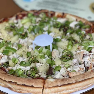 a pizza on a paper plate