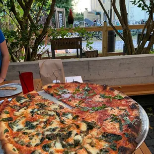 a large pizza on a wooden table