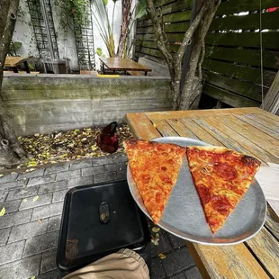2 slices while a rooster stares at me
