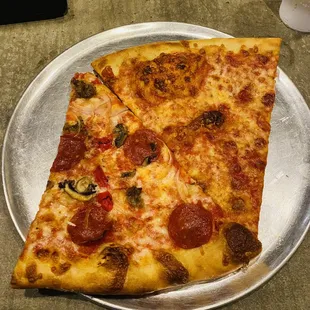 Slice of pizza d supreme and a cheese slice