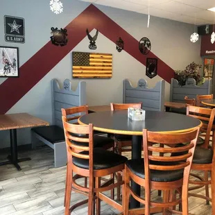tables and booths with american flags on the wall