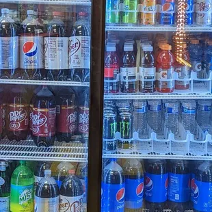 a refrigerator full of soda and soft drinks