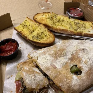 Deluxe calzone and garlic bread.