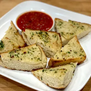 Garlic bread with side of marinara sauce.