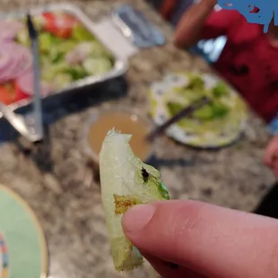 a hand holding a half eaten sandwich