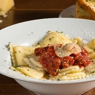 a bowl of pasta and bread