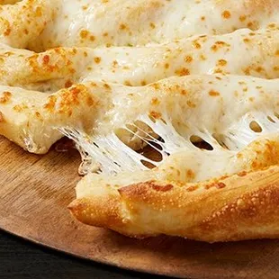 a slice of cheese pizza on a wooden board