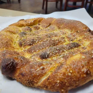 Their garlic bread is a small, pull-apart, pizza dough loaf.  Quite tasty, soft interior.