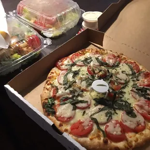 Our margarita pizza and 2 Caesar salads that came with garlic bread salads were good.