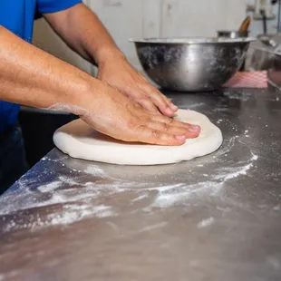 a person kneading dough