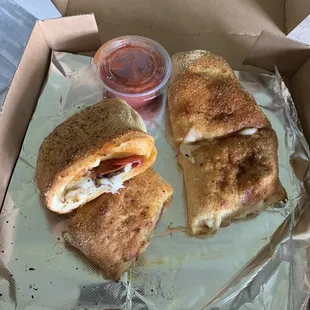 a half eaten sandwich in a box