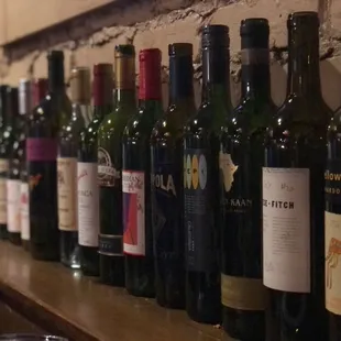 a row of wine bottles on a shelf
