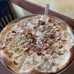 Made our own Alfredo pizza! This is the largest size and we include chicken, Proscuitto, basil, and sun dried tomatoes!