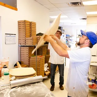 a pizza being made in a commercial kitchen