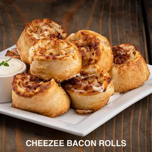 a plate of cheeze bacon rolls