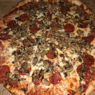 A large Sausage, Pepperoni, &amp; Fresh Mushrooms pizza