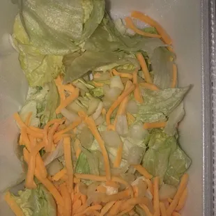 lettuce and cheese in a styrofoam container