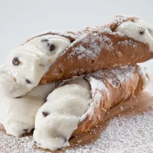 two chocolate chip doughnuts on a cutting board