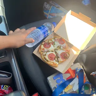 a person opening a box of pizza