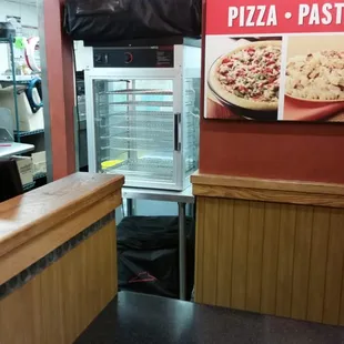 the front counter of a pizza restaurant