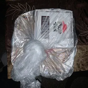 plastic wrap wrapped around a pizza box