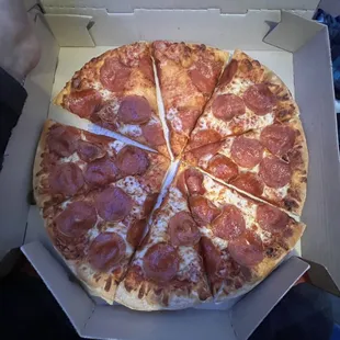 Pepperoni pizza with spots missing cheese