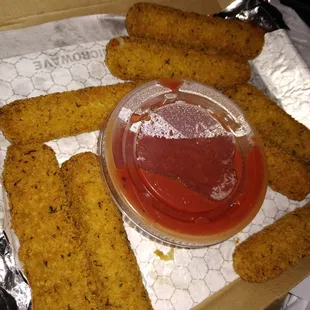 a box of fried fish sticks with ketchup
