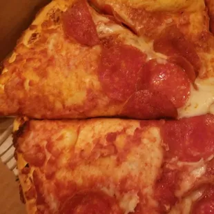 a slice of pepperoni pizza in a box