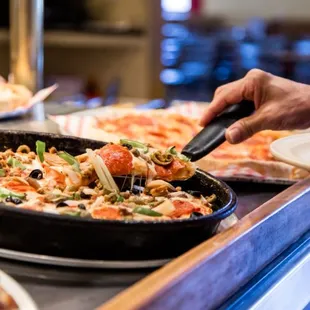 a pan of pizza being served