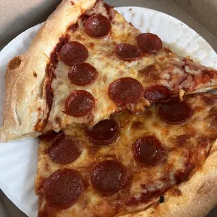 two slices of pepperoni pizza in a box