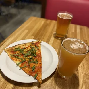 a slice of pizza and a glass of beer