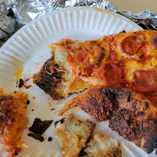 Pepperoni slice, no crust left after being burned away