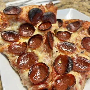 a slice of pepperoni pizza