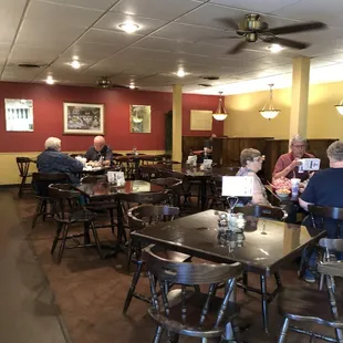 people sitting at tables in a restaurant