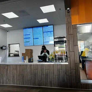 Menu and pickup counter also delicious mango frappe in the fridge behind.