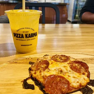 a half eaten pizza and a drink