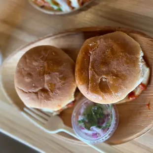 two sandwiches on a wooden plate