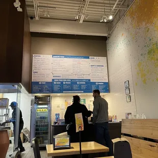 two people standing in a restaurant