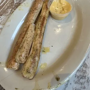 Breadsticks with dill butter on them