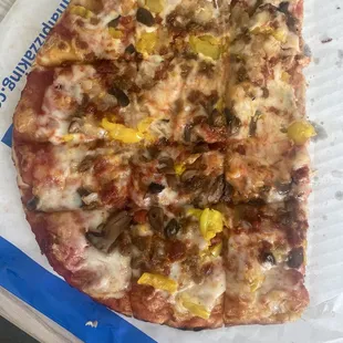 a slice of pizza on a piece of paper